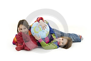 Children embracing world globe