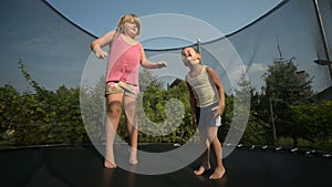 Children enjoy jumping on trampoline