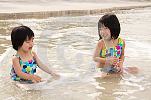 Children enjoy waves on beach