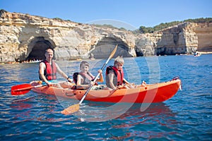 Children, enjoying Benagil, Portugal. Benagil Cave inside Algar de Benagil, famous sea cave in Algarve coast, Lagoa photo