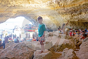 Children, enjoying Benagil, Portugal. Benagil Cave inside Algar de Benagil, famous sea cave in Algarve coast, Lagoa photo