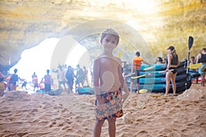 Children, enjoying Benagil, Portugal. Benagil Cave inside Algar de Benagil, famous sea cave in Algarve coast, Lagoa photo