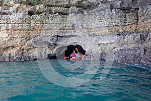 Children, enjoying Benagil, Portugal. Benagil Cave inside Algar de Benagil, famous sea cave in Algarve coast, Lagoa photo