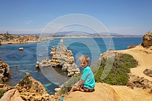 Children, enjoying Benagil, Portugal. Benagil Cave inside Algar de Benagil, famous sea cave in Algarve coast, Lagoa photo