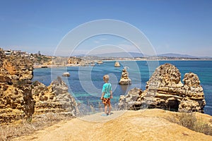 Children, enjoying Benagil, Portugal. Benagil Cave inside Algar de Benagil, famous sea cave in Algarve coast, Lagoa photo