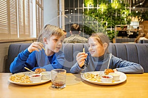 Children Enjoying Burger Meal Together