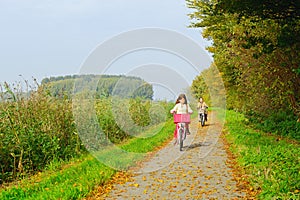 Children enjoying nature on bicycle