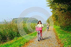 Children enjoying nature on bicycle