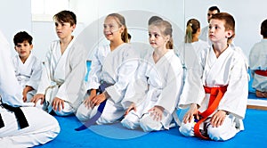 Children enjoying their trainings with coach at karate