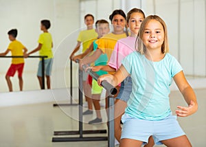 Children exercising ballet moves in studio