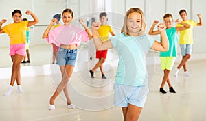 Children exercising dance moves together