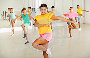 Children exercising modern dance moves together