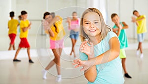 Children exercising modern dance moves together