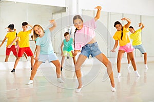 Children exercising modern dance moves together