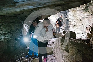 Children explore an underground cave with pile, adventurously