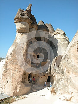 Children exploring the fairy chimney houses at Cappadocia, Turkey