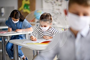 Children with face mask back at school after covid-19 quarantine and lockdown.