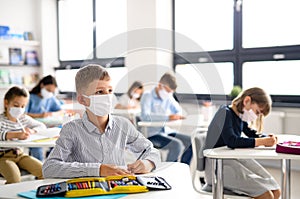 Children with face mask back at school after covid-19 quarantine and lockdown.