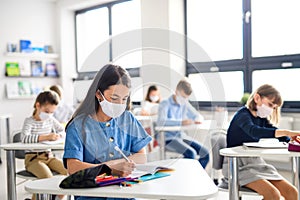 Children with face mask back at school after covid-19 quarantine and lockdown.