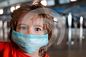 Children face in a protective mask. Frightened scared boy kid. Beautiful childrens eyes. Children and coronavirus