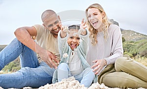 Children, family and beach with girl, mother and father playing in the sand while bonding on holiday or vacation. Travel