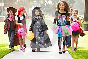 Children In Fancy Costume Dress Going Trick Or Treating