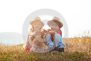 Children farmer in the farm with countryside background. Active family leisure with kids. Springtime on the ranch