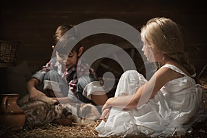 Children feed kittens milk