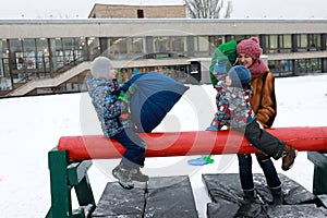 Children fight on log with bags