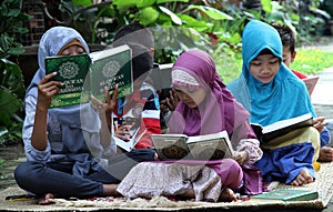 Children fill the school holidays by reading the Qur'an in one of the non-formal education in the city of Solo, Central Java Indon