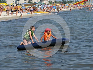 Children float on an inflatable mattress