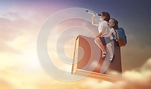 Children flying on the book