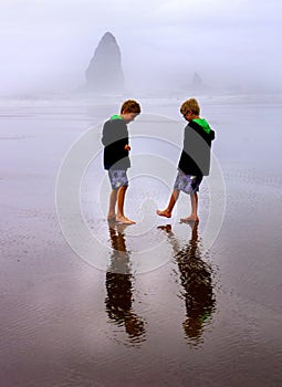 Children on Foggy Beach Vertical