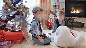 Children fooling around near the Christmas tree