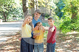 Children in the forest with a compass look and point their finge photo