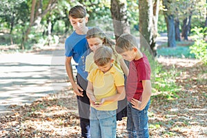 Children in the forest use a compass to study the direction of movement. The concept of children and adolescents outdoor photo