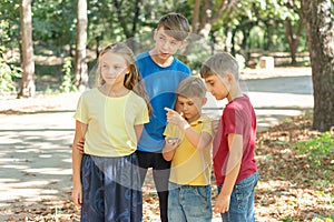 Children in the forest use a compass to study the direction of movement. The concept of children and adolescents outdoor photo