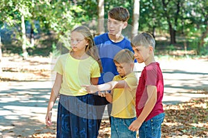 Children in the forest use a compass to study the direction of movement. The concept of children and adolescents outdoor photo