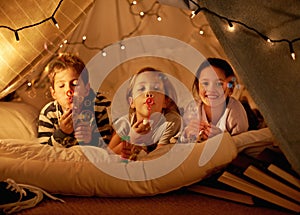 Children, fort and portrait of siblings in a bed with fun, toy and bonding while blowing bubbles at home together