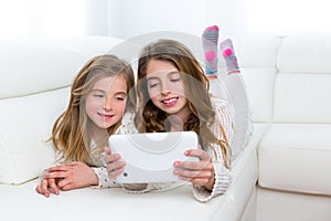 Children friends kid girls playing together with tablet pc