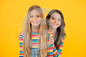 Children are the future. Happy children with long hair yellow background. Small children in casual style. Little