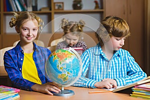 Children on the geography lesson in school classroom. Educational concept