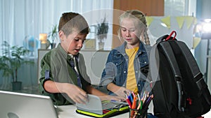 children getting ready to go to school, brother and sister pack books and pencil case with colorful pencils in backpack