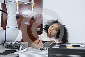 Children girl African American using joystick and Girl African American control smart robotics arm at class room. electric system