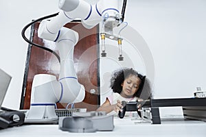 Children girl African American using joystick and Girl African American control smart robotics arm at class room. electric system