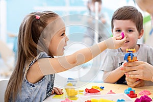 Children girl and boy play in kids daycare center