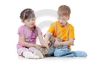Children girl and boy stroking kittens