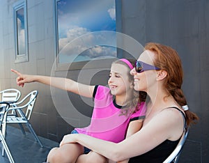 Children girl daughter sitting on mother lap