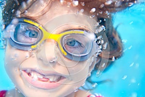 Children girl funny underwater with goggles