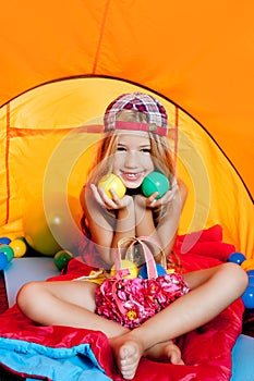 Children girl playing inside camping tent